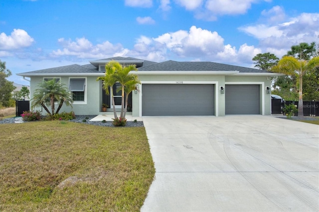 view of front of house featuring a garage and a front lawn