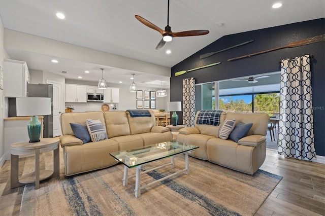 living room with lofted ceiling, hardwood / wood-style flooring, plenty of natural light, and ceiling fan