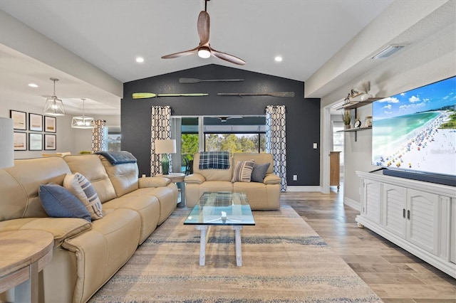 living room featuring lofted ceiling, light hardwood / wood-style floors, and ceiling fan