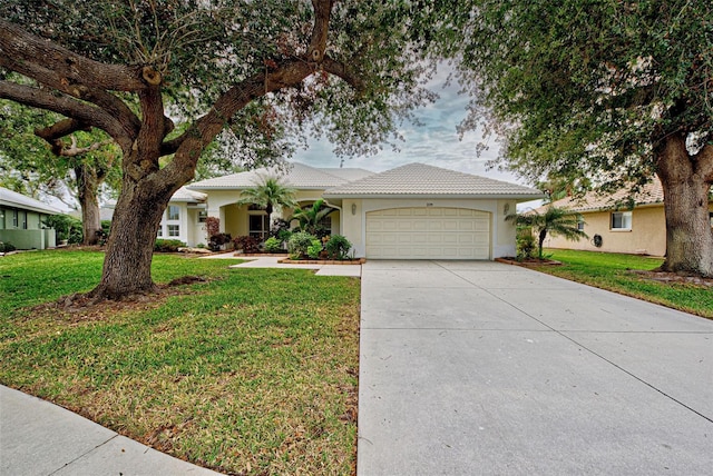 ranch-style home featuring a garage and a front lawn