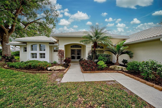 mediterranean / spanish-style house featuring a front yard