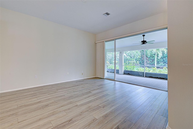 empty room featuring ceiling fan and light wood-type flooring