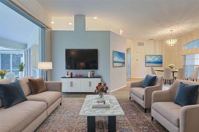 living room with an inviting chandelier and wood-type flooring