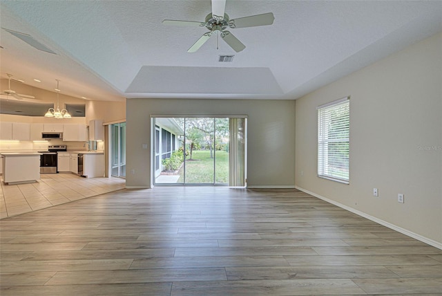 unfurnished living room featuring plenty of natural light and light hardwood / wood-style floors