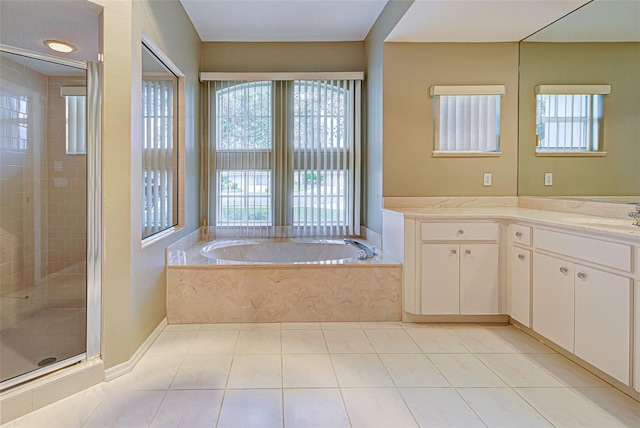 bathroom featuring plus walk in shower, tile patterned floors, and vanity