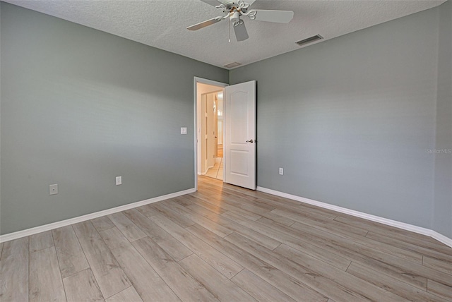 unfurnished room featuring ceiling fan, a textured ceiling, and light wood-type flooring