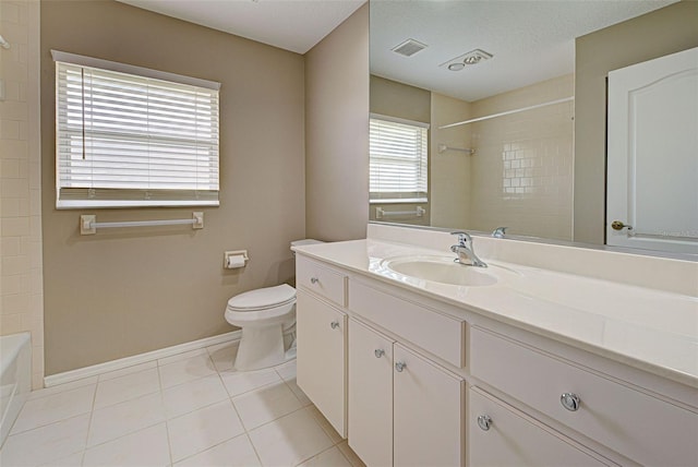 full bathroom featuring tile patterned floors, toilet, tiled shower / bath combo, and vanity