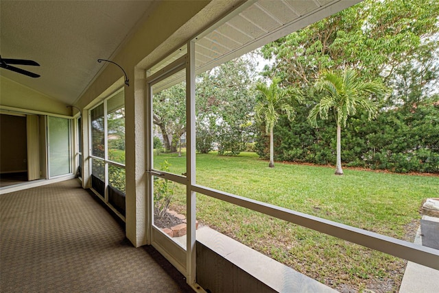 unfurnished sunroom featuring vaulted ceiling and ceiling fan