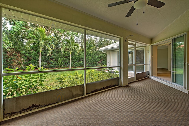 unfurnished sunroom featuring lofted ceiling and ceiling fan