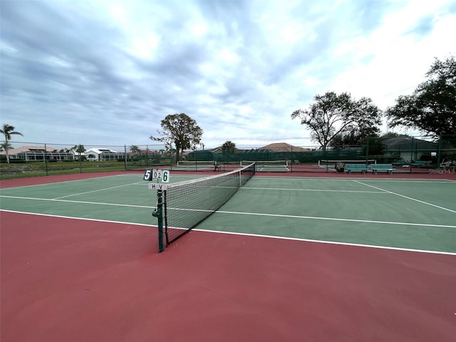 view of tennis court with basketball hoop