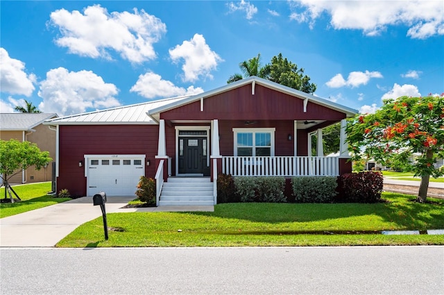 view of front of property featuring a porch, a garage, and a front yard