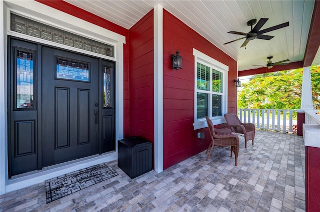 doorway to property with ceiling fan and covered porch