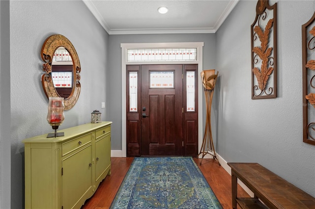 foyer entrance with ornamental molding and dark hardwood / wood-style floors