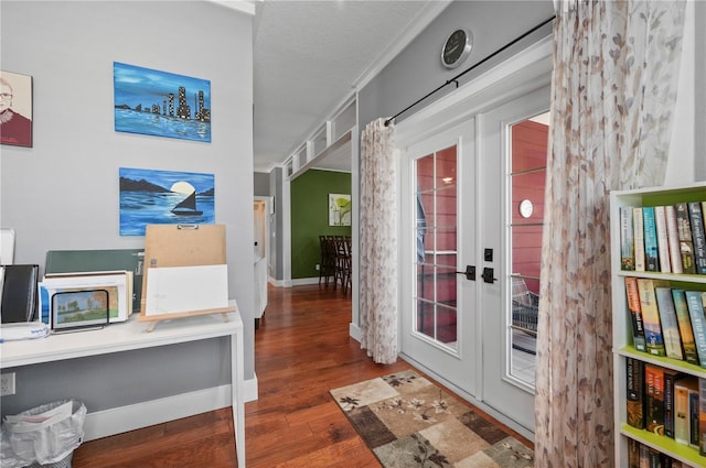 interior space with dark hardwood / wood-style flooring, ornamental molding, and french doors