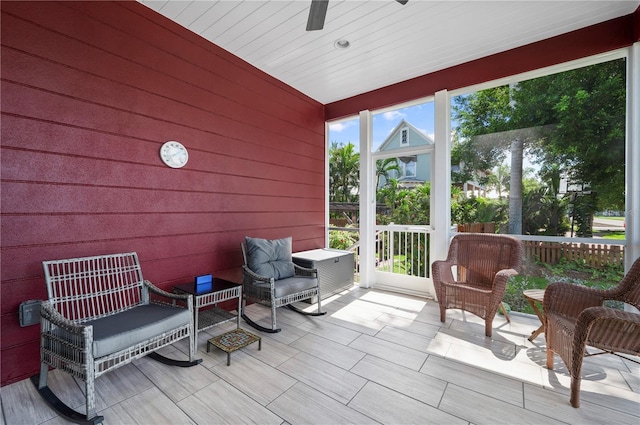 sunroom / solarium featuring ceiling fan