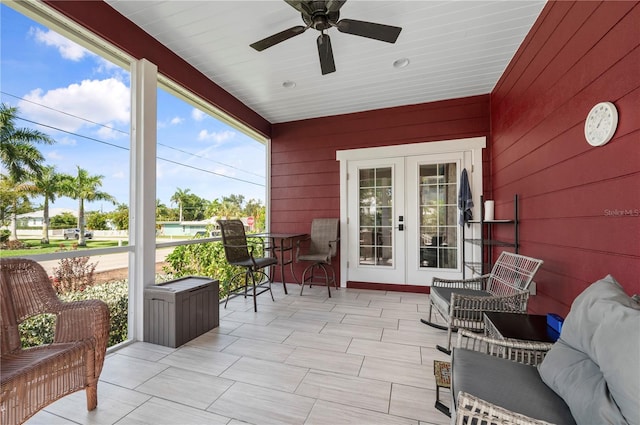 sunroom with ceiling fan and french doors