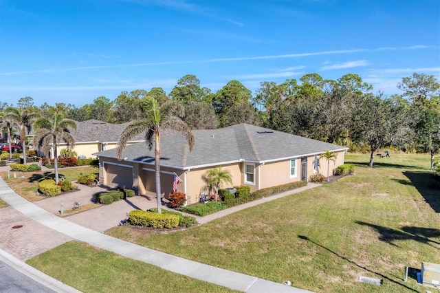 view of front of house featuring a garage and a front lawn