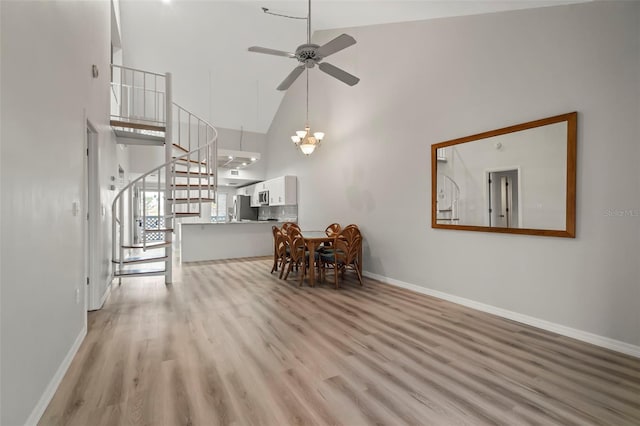 living room featuring ceiling fan, high vaulted ceiling, and light wood-type flooring