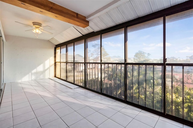 unfurnished sunroom featuring ceiling fan and beam ceiling