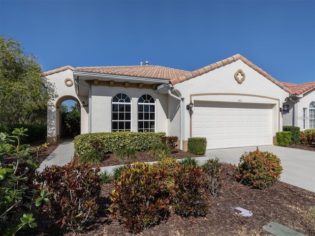 mediterranean / spanish-style home with a garage