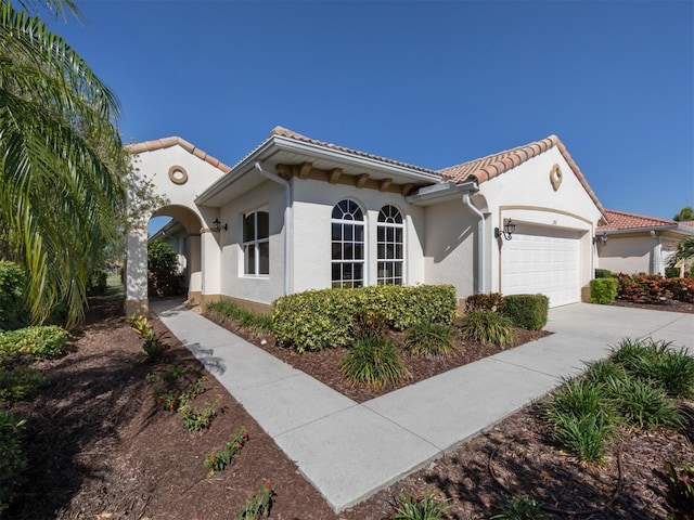 mediterranean / spanish house featuring a garage