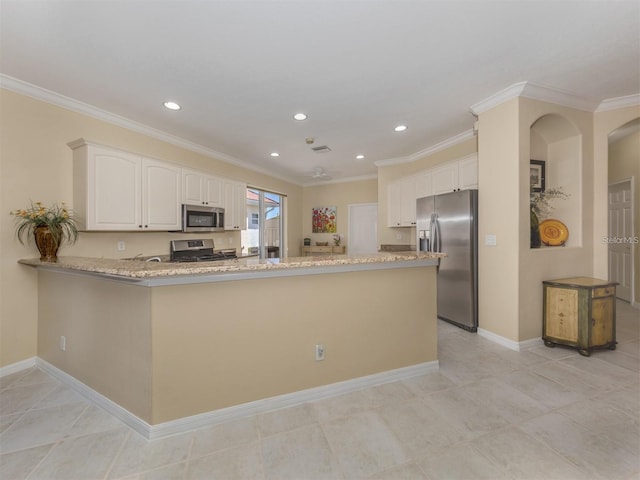 kitchen featuring appliances with stainless steel finishes, white cabinetry, light stone counters, ornamental molding, and kitchen peninsula