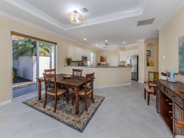 tiled dining room with ornamental molding