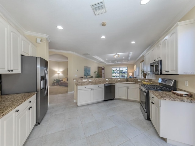 kitchen featuring white cabinetry, appliances with stainless steel finishes, and kitchen peninsula