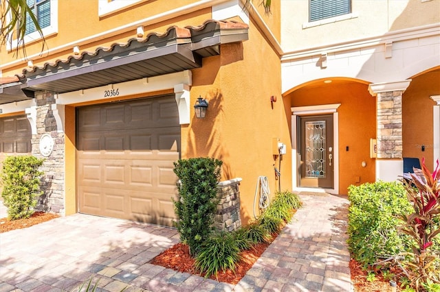 view of exterior entry featuring a garage