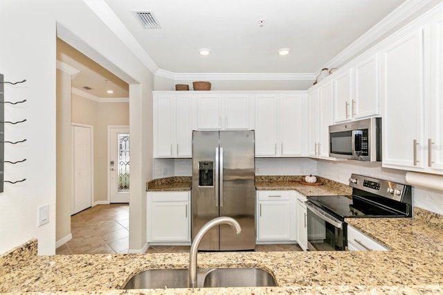 kitchen with sink, crown molding, white cabinetry, stainless steel appliances, and light stone counters