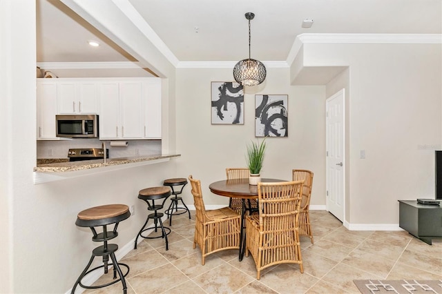 dining area with light tile patterned floors and ornamental molding