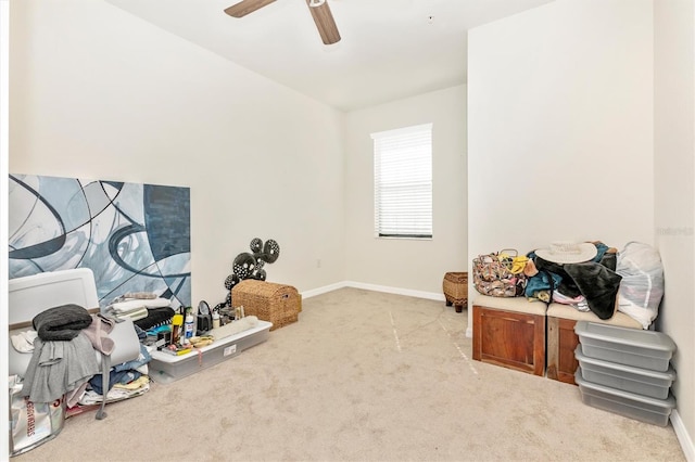 interior space featuring light colored carpet and ceiling fan