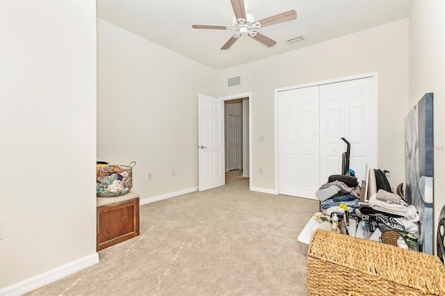 interior space with ceiling fan and light carpet