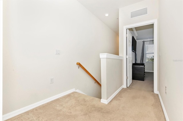 hall with light colored carpet