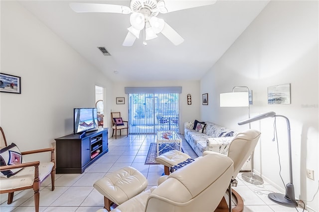 living room featuring ceiling fan, vaulted ceiling, and light tile patterned floors