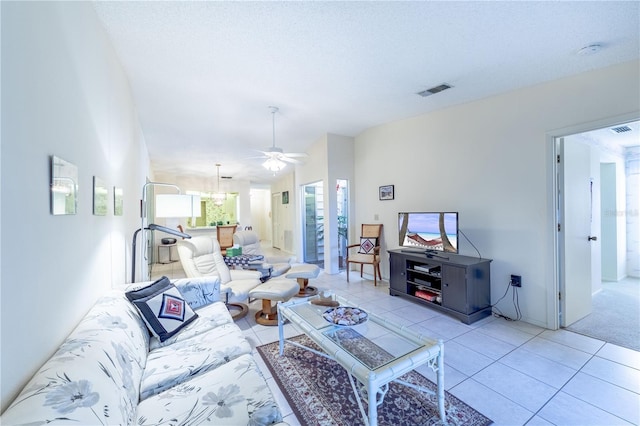 living room featuring light tile patterned flooring, ceiling fan, vaulted ceiling, and a textured ceiling