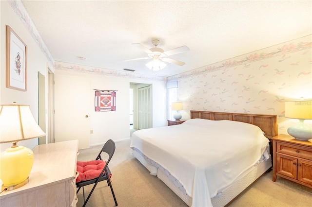 carpeted bedroom with crown molding, ceiling fan, a closet, and a textured ceiling