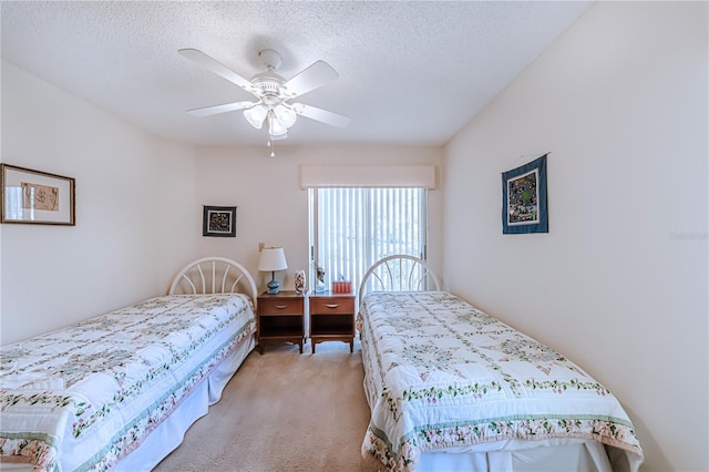 bedroom featuring ceiling fan, light colored carpet, and a textured ceiling