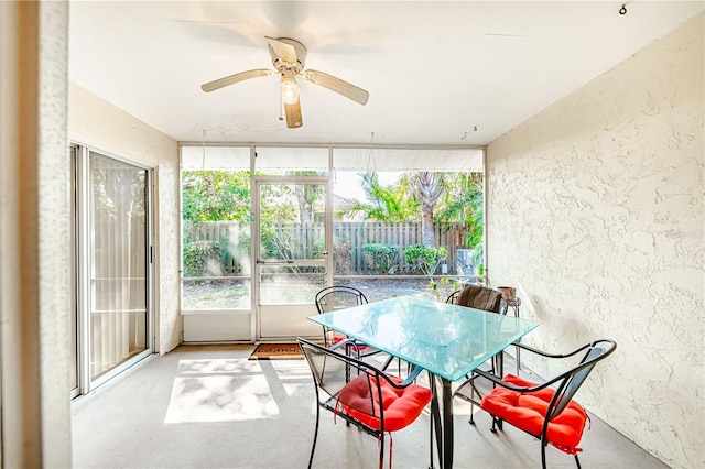 sunroom / solarium featuring ceiling fan