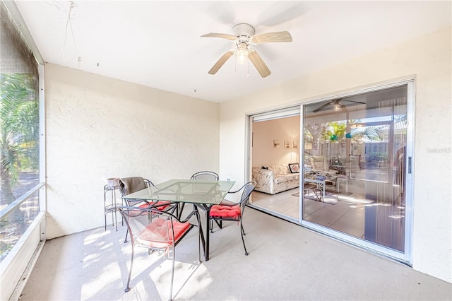 sunroom / solarium featuring ceiling fan