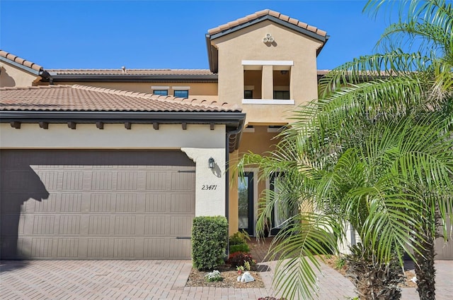 mediterranean / spanish home with a garage