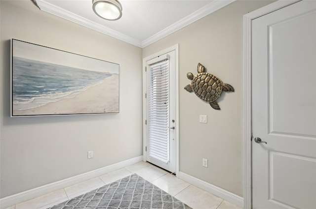 tiled entryway featuring crown molding