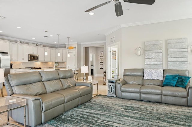 living room with crown molding and ceiling fan