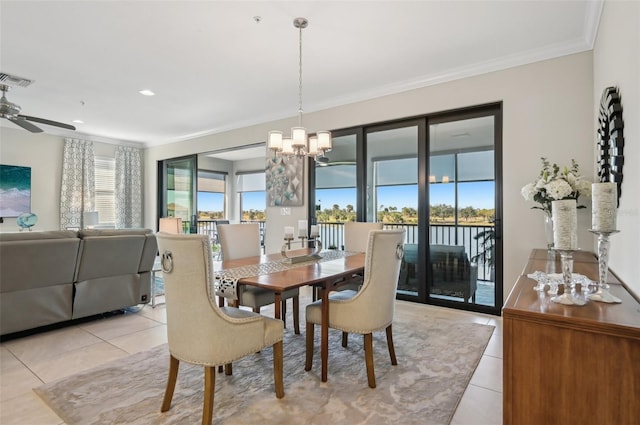 dining room with crown molding, plenty of natural light, light tile patterned floors, and ceiling fan with notable chandelier