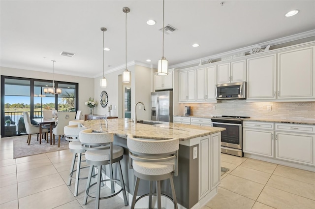 kitchen with stainless steel appliances, sink, a center island with sink, and white cabinets