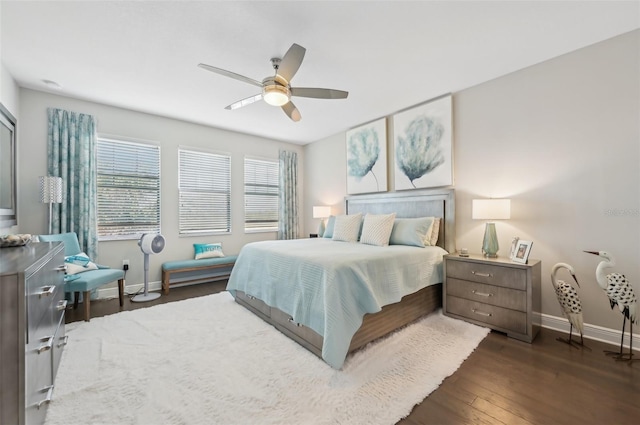 bedroom with ceiling fan and dark hardwood / wood-style floors