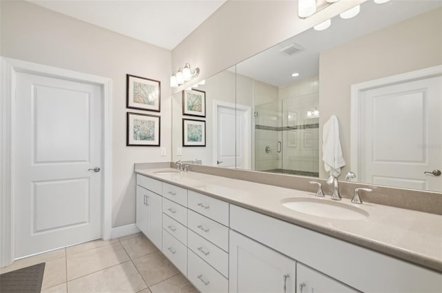 bathroom featuring tile patterned flooring, vanity, and a shower with shower door