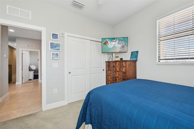 carpeted bedroom with a closet and ceiling fan