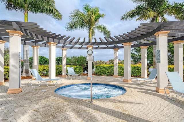 view of pool featuring a community hot tub, a pergola, and a patio area