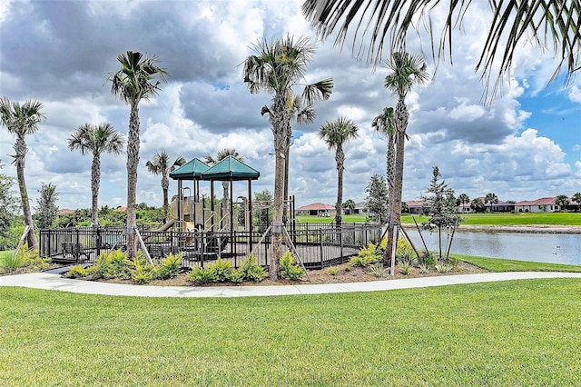 view of jungle gym with a water view and a lawn